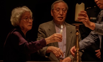 A candle is lit to honor families divided by the Korean War