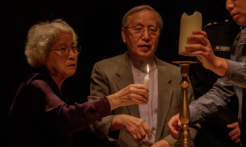 A candle is lit to honor families divided by the Korean War